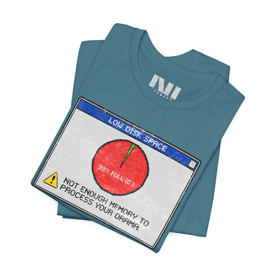 folded Heather deep Teal blue graphic t-shirt featuring a retro computer error message that reads "Not enough memory to process your drama" with a 99% full disk pie chart icon. #Heather Deep Teal