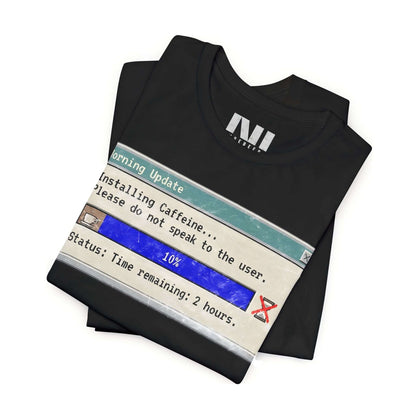 Folded Black graphic t-shirt featuring a retro computer "Morning Update" progress bar design with the text "Installing Caffeine... Please do not speak to the user." #Black