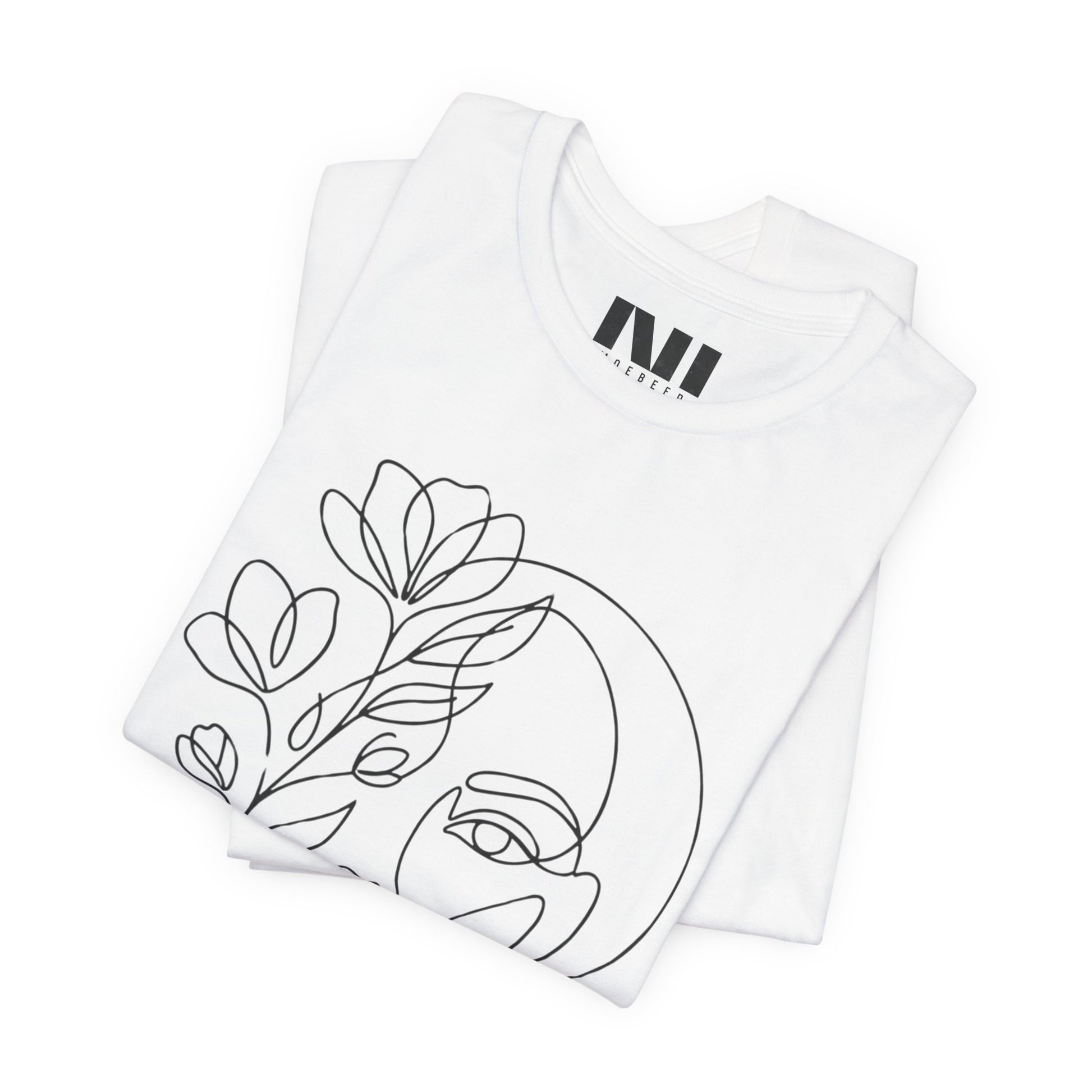 Folded White graphic t-shirt featuring a minimalist black continuous line art design of a woman's face blooming with floral botanical elements. MOEBEER tees #White