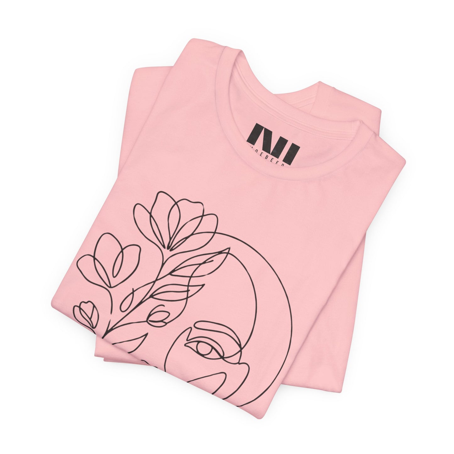 Folded Pink graphic t-shirt featuring a minimalist black continuous line art design of a woman's face blooming with floral botanical elements. MOEBEER tees #Pink