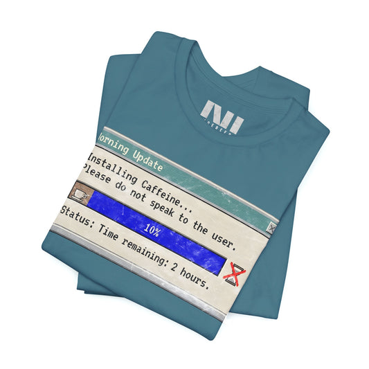 folded heather deep Teal blue graphic t-shirt featuring a retro computer "Morning Update" progress bar design with the text "Installing Caffeine... Please do not speak to the user." #Heather Deep Teal