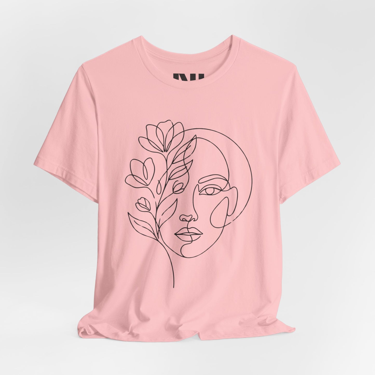 Pink graphic t-shirt featuring a minimalist black continuous line art design of a woman's face blooming with floral botanical elements. MOEBEER tees #Pink