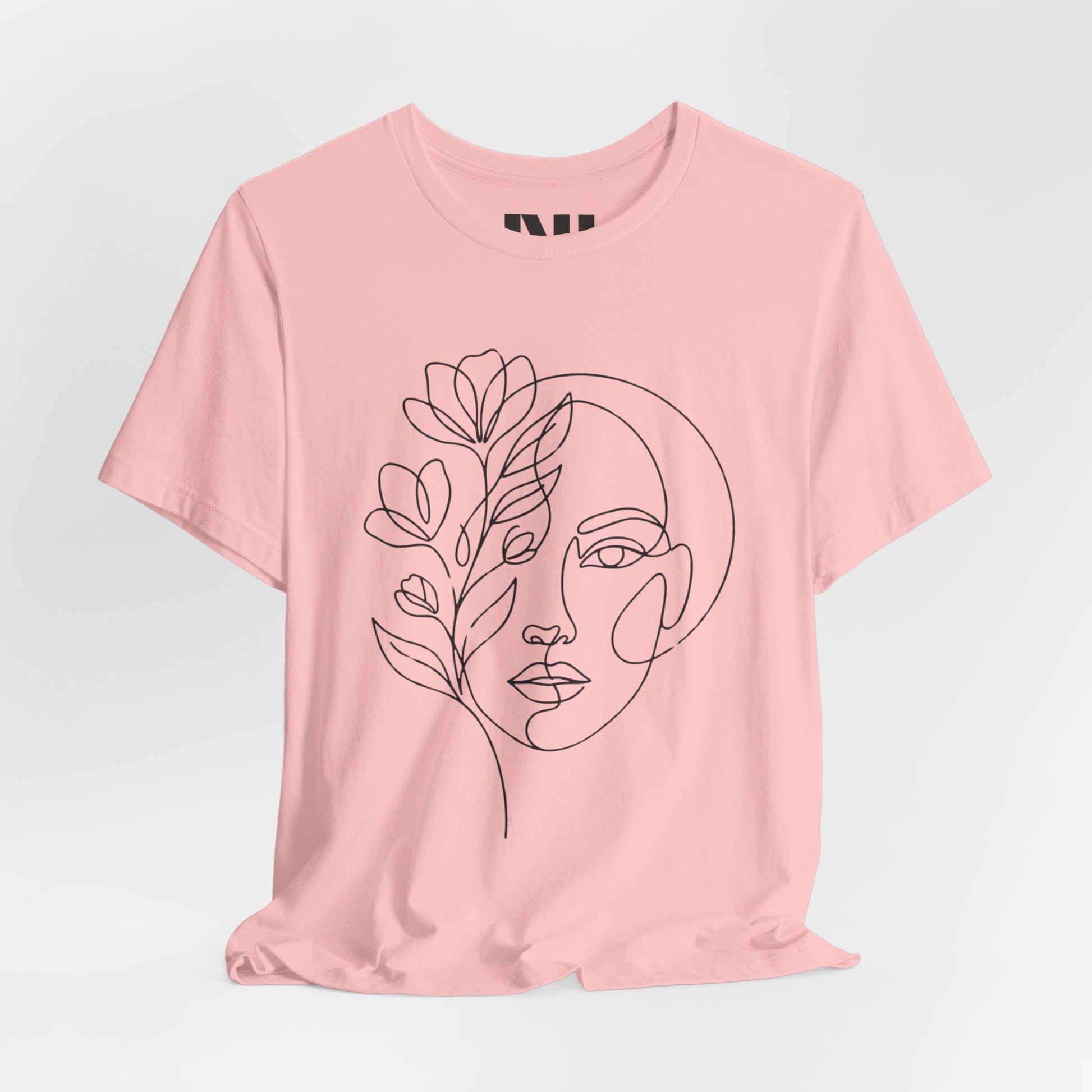 Pink graphic t-shirt featuring a minimalist black continuous line art design of a woman's face blooming with floral botanical elements. MOEBEER tees #Pink
