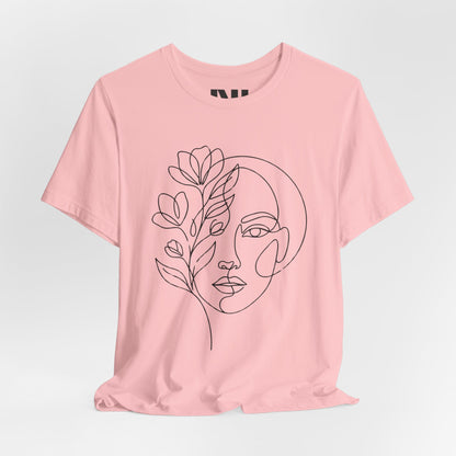 Pink graphic t-shirt featuring a minimalist black continuous line art design of a woman's face blooming with floral botanical elements. MOEBEER tees #Pink