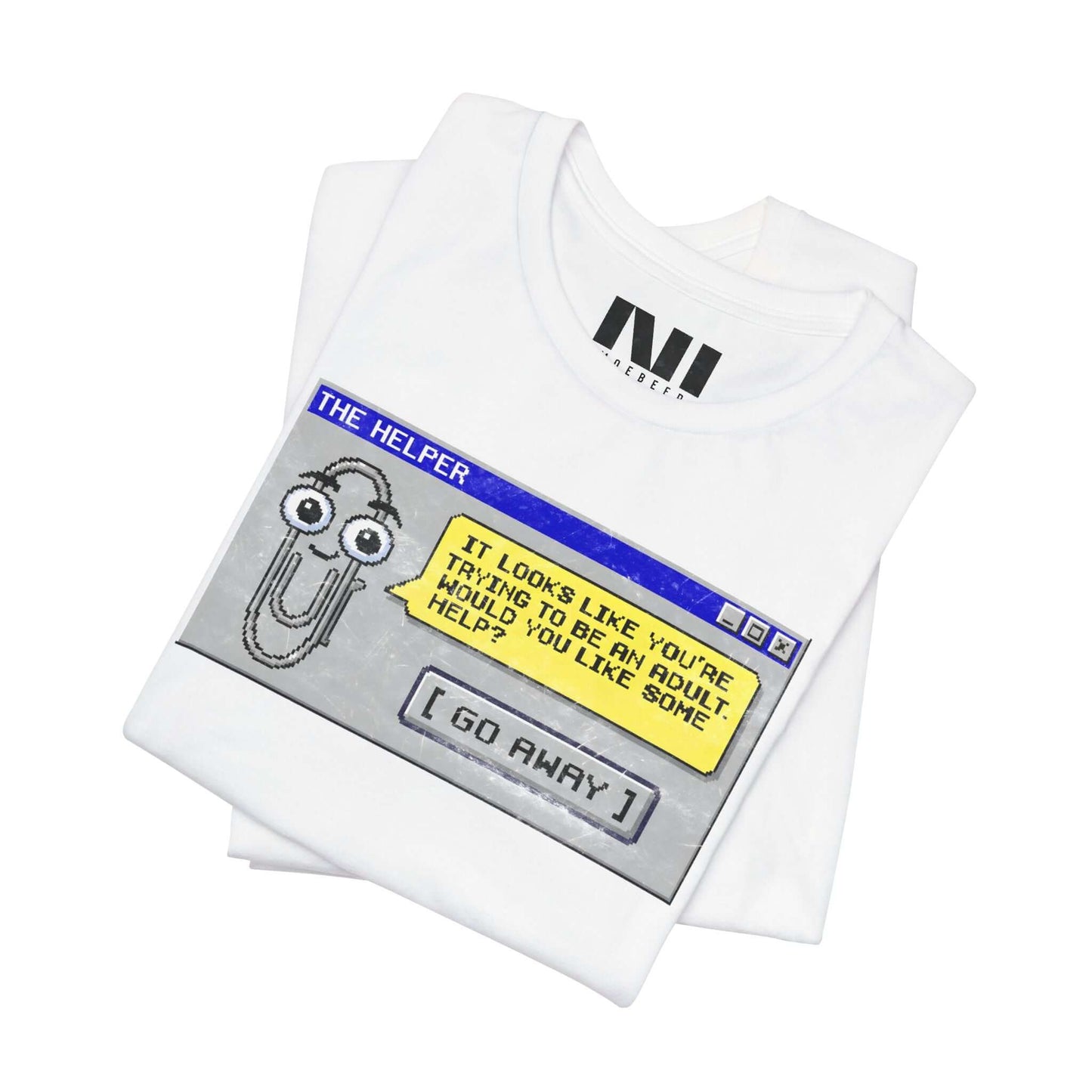 Folded White t-shirt featuring a retro pixelated computer pop-up window graphic with a cartoon paperclip assistant. The text within the window reads, "IT LOOKS LIKE YOU'RE TRYING TO BE AN ADULT. WOULD YOU LIKE SOME HELP?" followed by a button that says "[ GO AWAY ]" #White