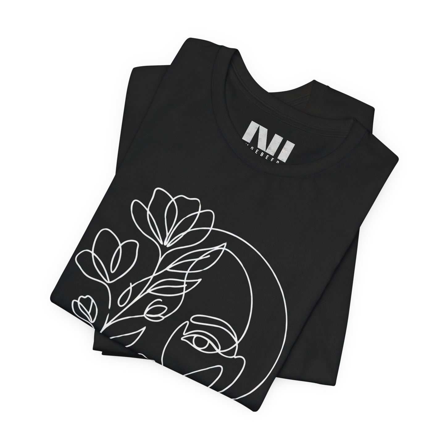 Folded Black graphic t-shirt featuring a minimalist black continuous line art design of a woman's face blooming with floral botanical elements. MOEBEER tees #Black