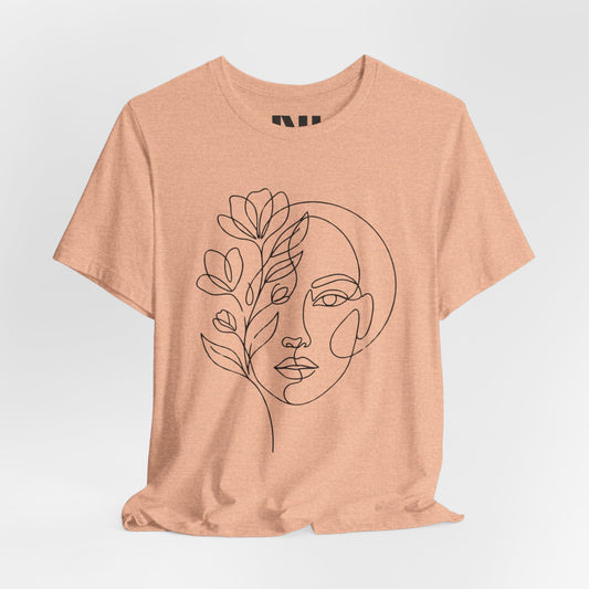 Heather Peach graphic t-shirt featuring a minimalist black continuous line art design of a woman's face blooming with floral botanical elements. #Heather Peach