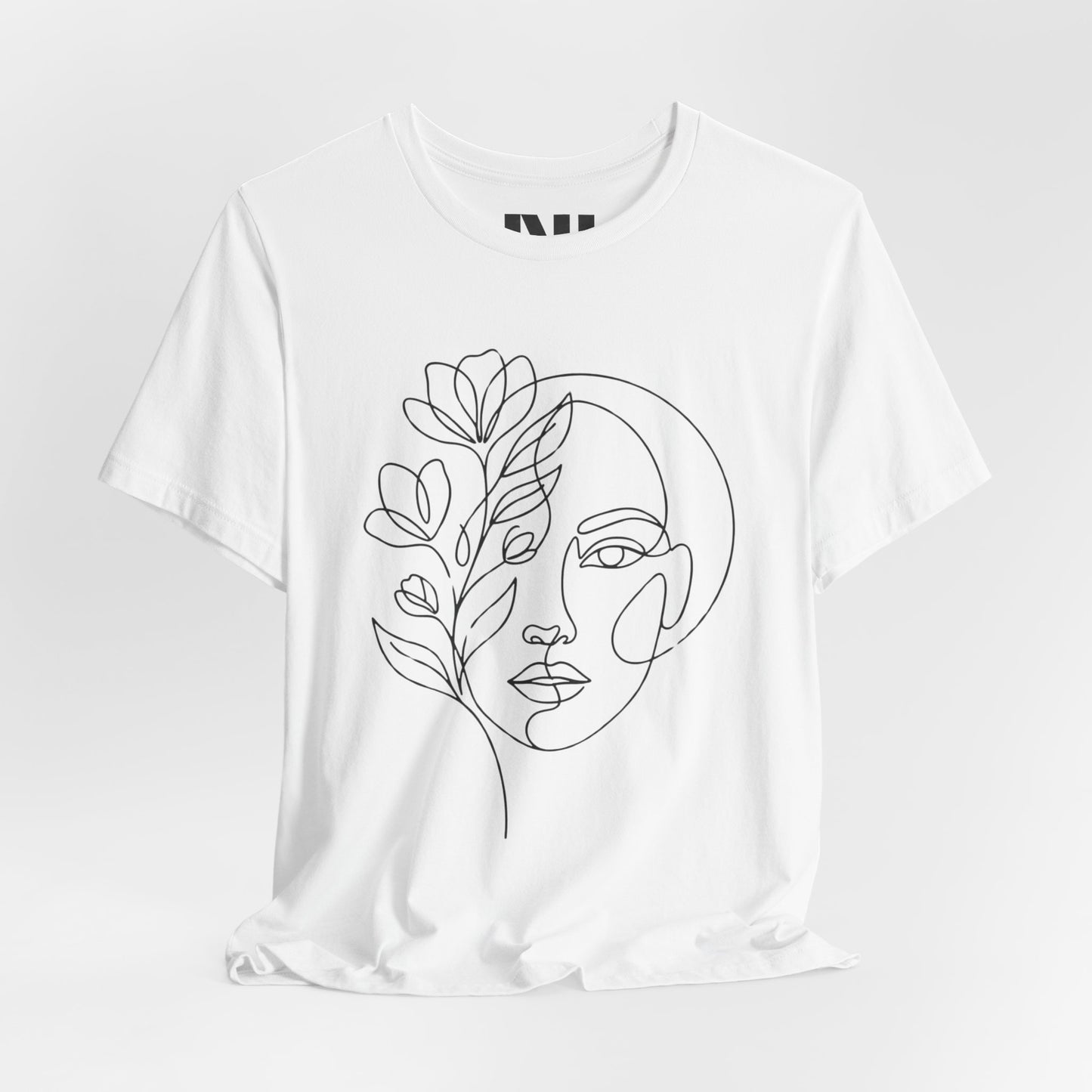 White graphic t-shirt featuring a minimalist black continuous line art design of a woman's face blooming with floral botanical elements. MOEBEER tees #White
