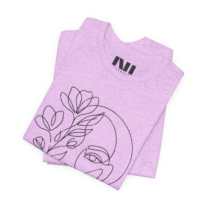 Folded Heathered Prism Lilac graphic t-shirt featuring a minimalist black continuous line art design of a woman's face blooming with floral botanical elements. MOEBEER tees #Heather Prism Lilac