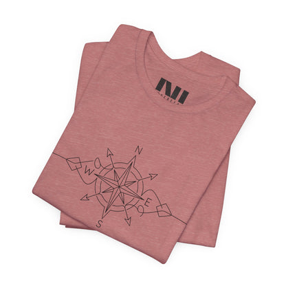folded heather mauve color graphic t-shirt featuring a minimalist black line art compass rose design with cardinal direction markers. #Heather Mauve
