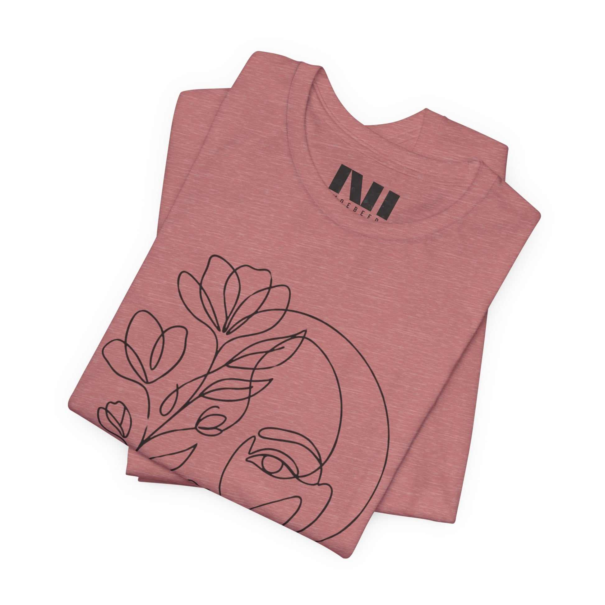 Folded Mauve Heathered graphic t-shirt featuring a minimalist black continuous line art design of a woman's face blooming with floral botanical elements. MOEBEER tees #Heather Mauve
