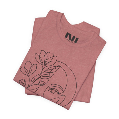Folded Mauve Heathered graphic t-shirt featuring a minimalist black continuous line art design of a woman's face blooming with floral botanical elements. MOEBEER tees #Heather Mauve