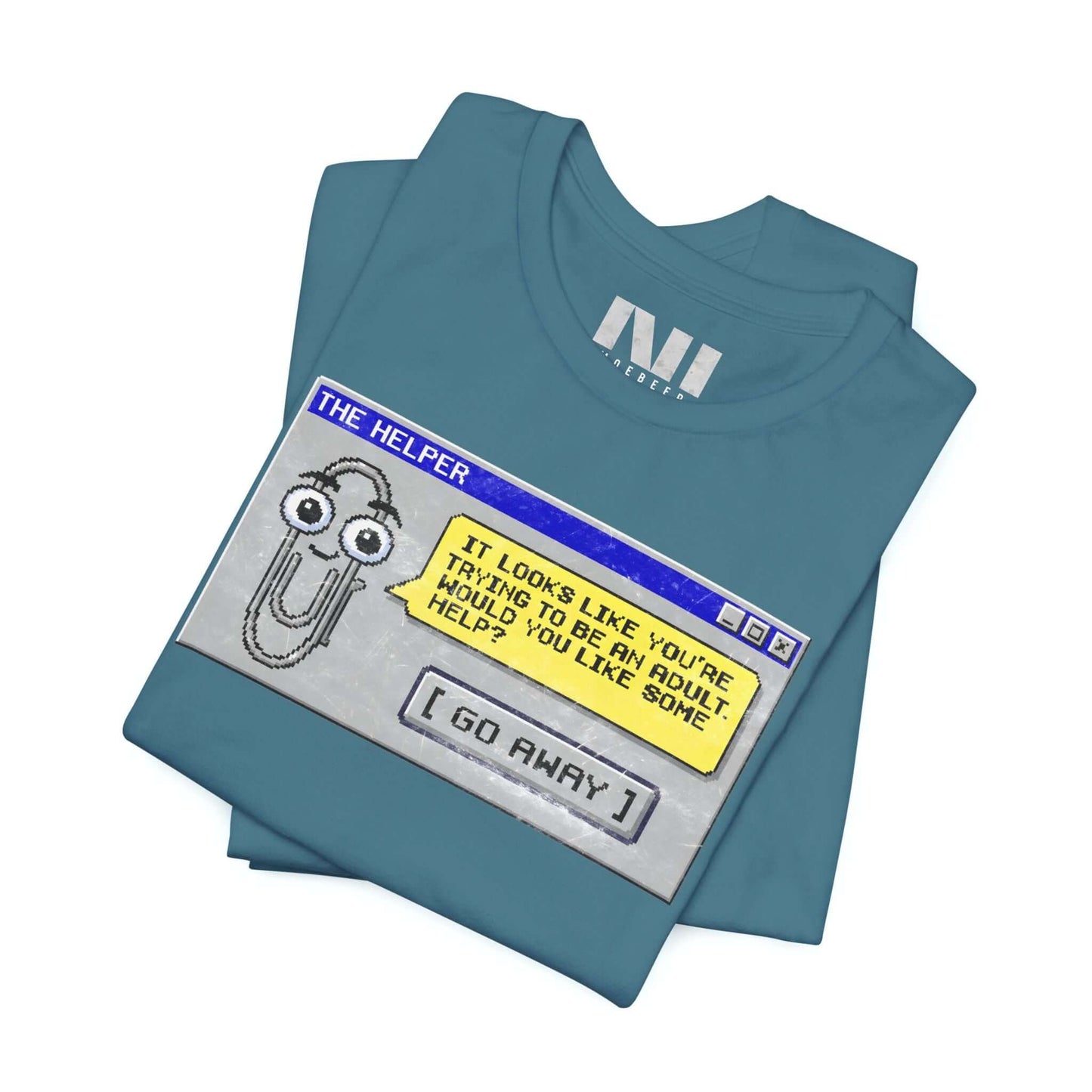 folded Heather deep Teal t-shirt featuring a retro pixelated computer pop-up window graphic with a cartoon paperclip assistant. The text within the window reads, "IT LOOKS LIKE YOU'RE TRYING TO BE AN ADULT. WOULD YOU LIKE SOME HELP?" followed by a button that says "[ GO AWAY ]" #Heather Deep Teal