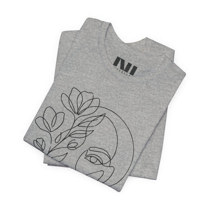 Folded Grey Heathered graphic t-shirt featuring a minimalist black continuous line art design of a woman's face blooming with floral botanical elements. MOEBEER tees #Athletic Heather