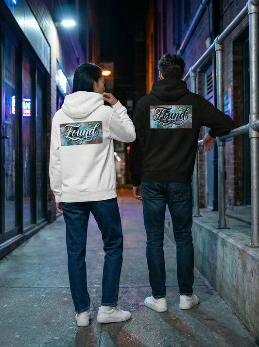 Two people wearing  MOEBEER Hoodie featuring "Found" script over a colorful abstract paint design 