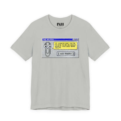 Heather athletic grey t-shirt featuring a retro pixelated computer pop-up window graphic with a cartoon paperclip assistant. The text within the window reads, "IT LOOKS LIKE YOU'RE TRYING TO BE AN ADULT. WOULD YOU LIKE SOME HELP?" followed by a button that says "[ GO AWAY ]" #Athletic Heather