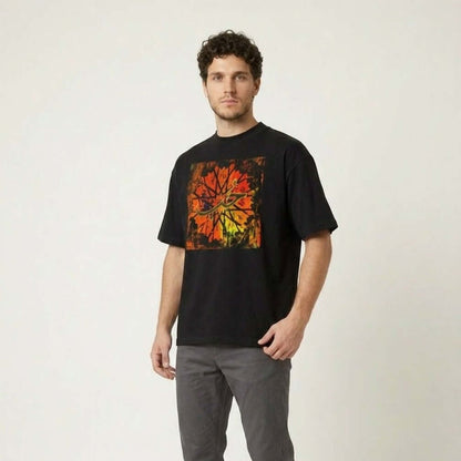 Man wearing a black t-shirt with a colorful design and gray pants on a white background #Black