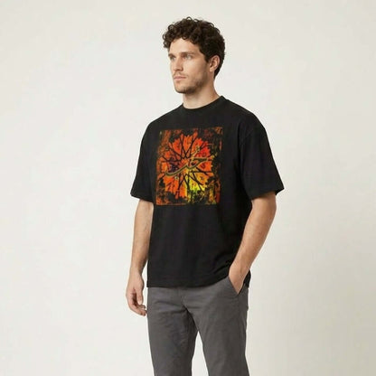 Man wearing a black t-shirt with a colorful design and gray pants on a white background #Black