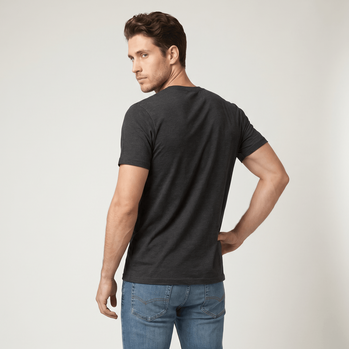 Man wearing a black t-shirt and blue jeans on a white background #Dark Grey Heather