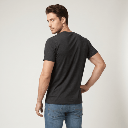 Man wearing a black t-shirt and blue jeans on a white background #Dark Grey Heather