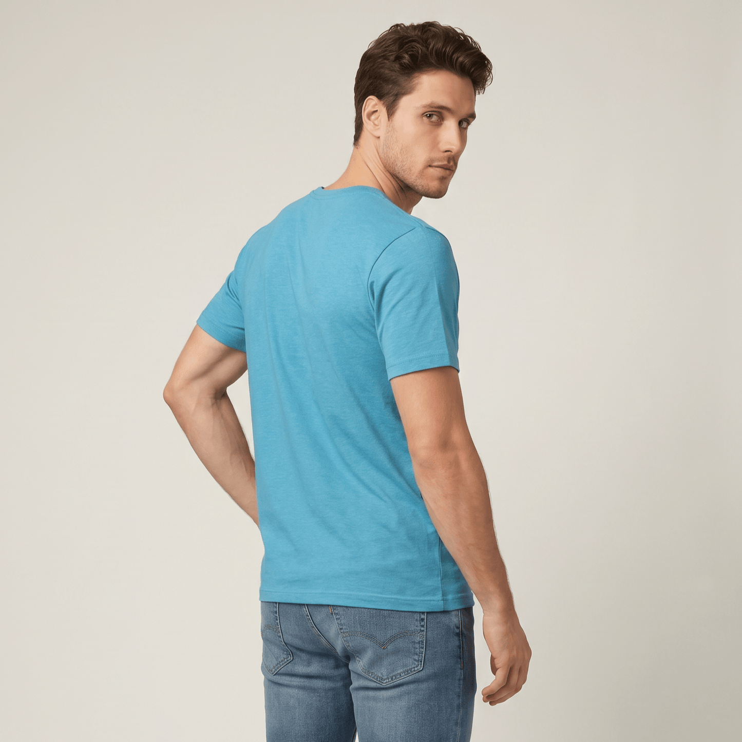Man wearing a blue t-shirt and jeans on a plain background #Heather Aqua