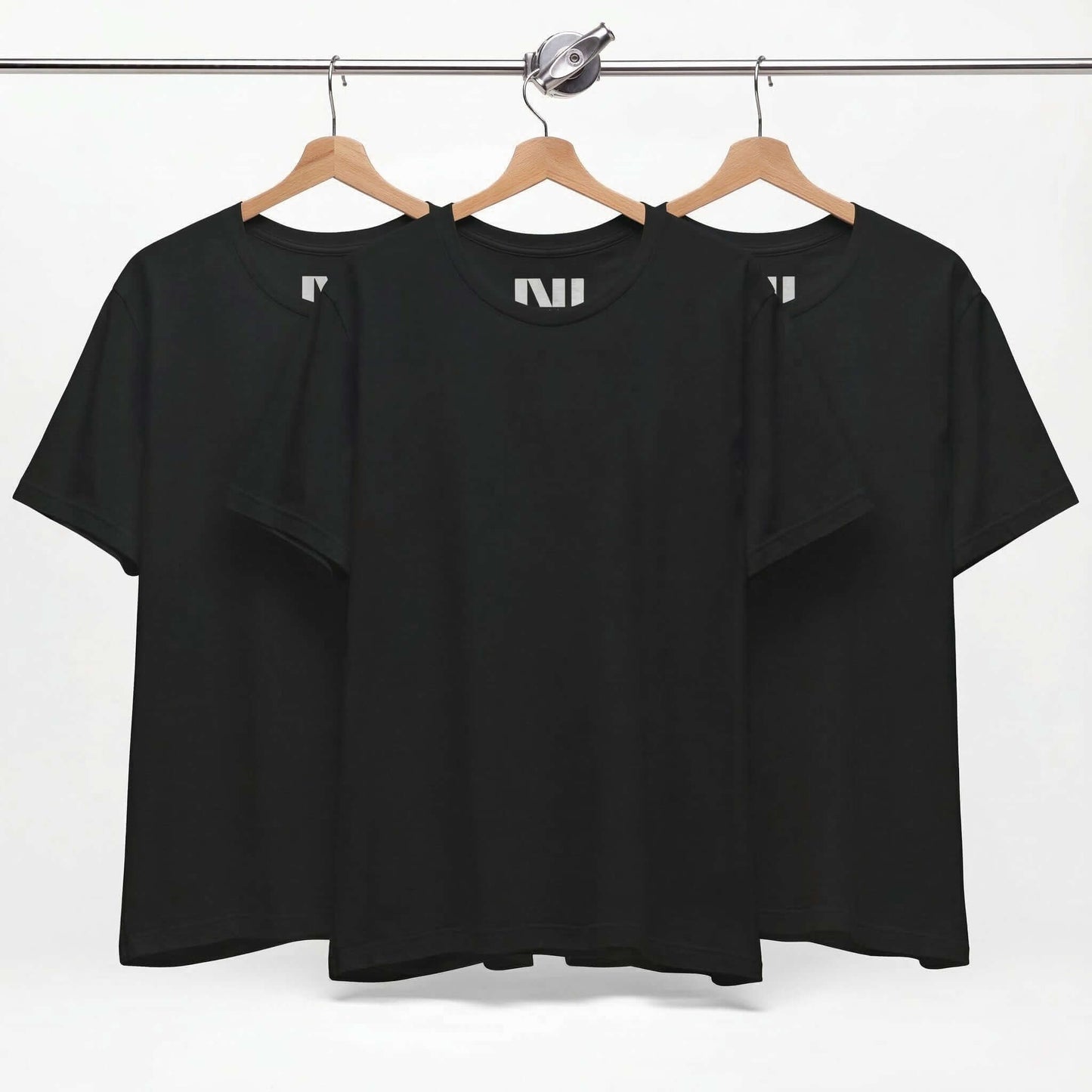 Tailored fit black t-shirt displayed on hangers, showcasing a classic black tee design in 100% cotton.