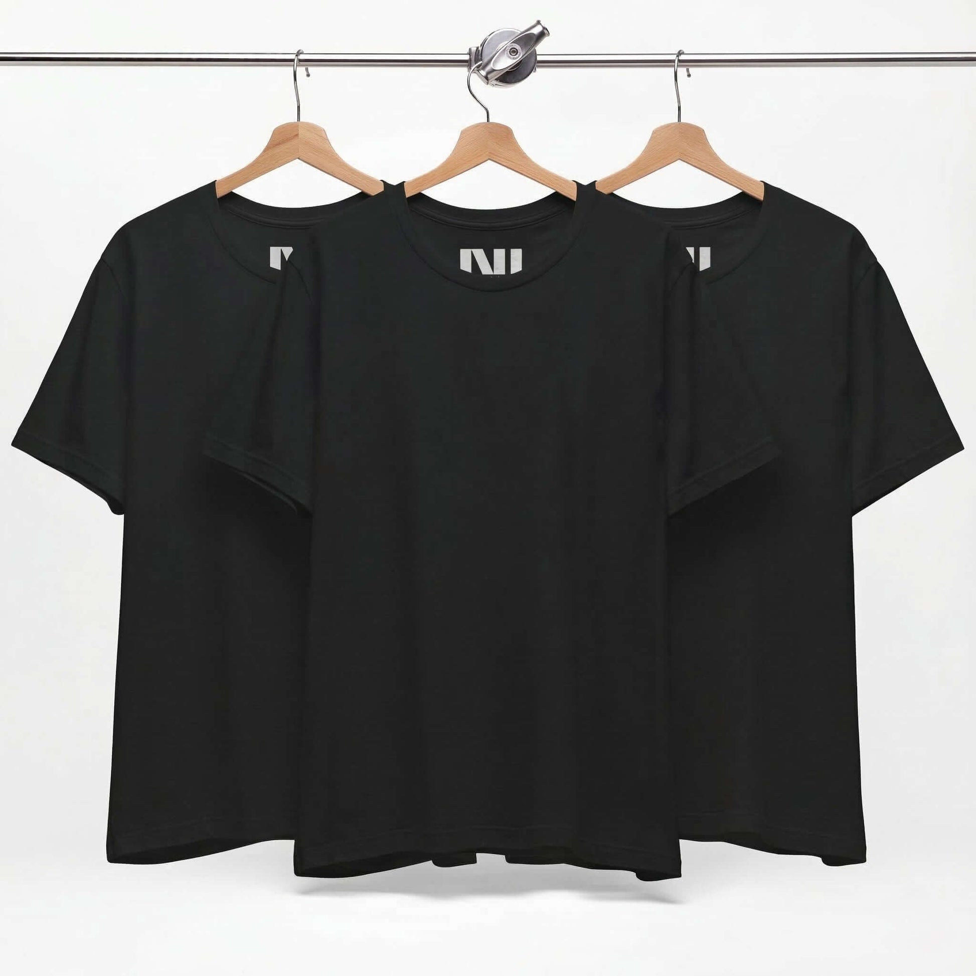 Tailored fit black t-shirt displayed on hangers, showcasing a classic black tee design in 100% cotton.