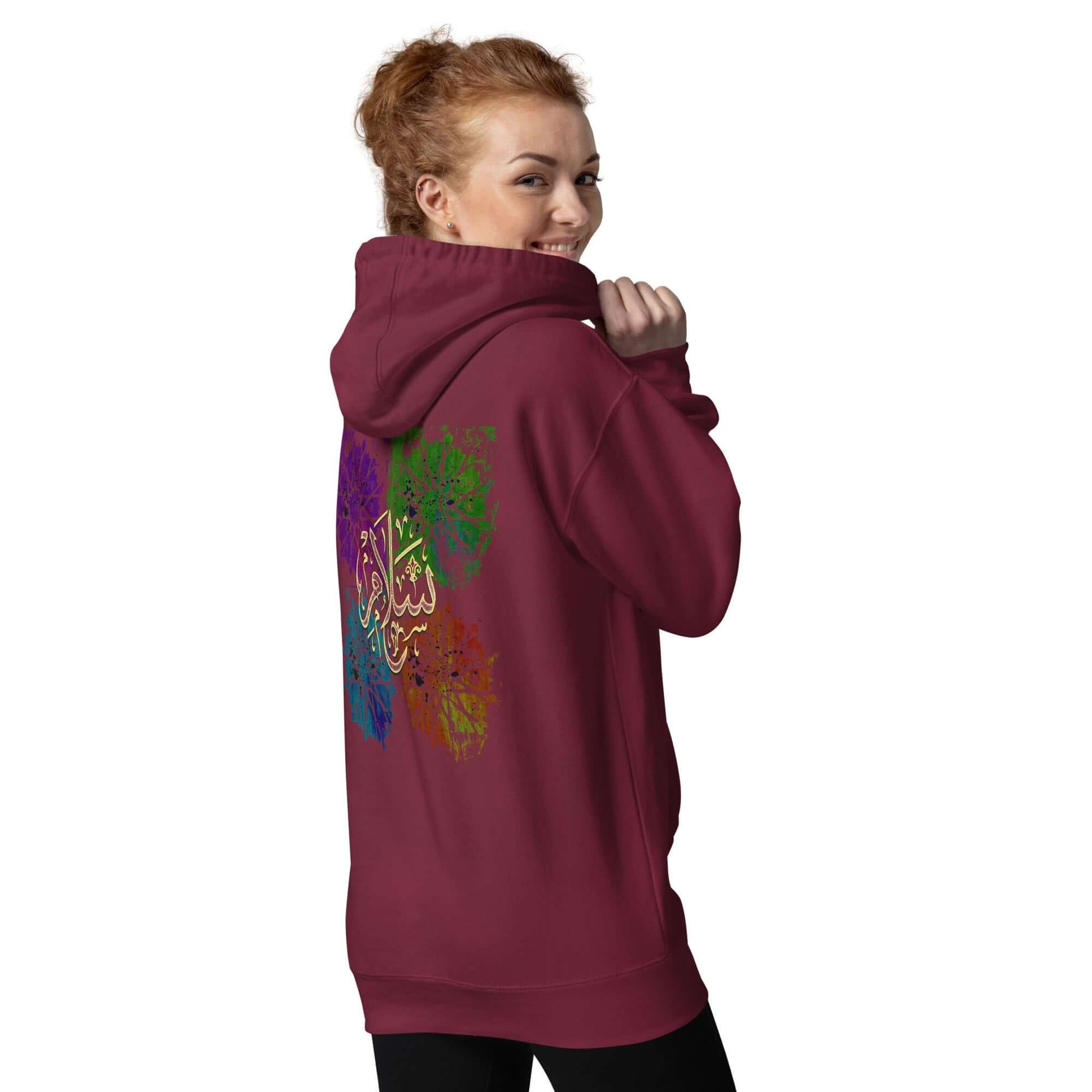 Woman wearing a maroon Arabic calligraphy hoodie with colorful design, showcasing the word Salam. #Maroon